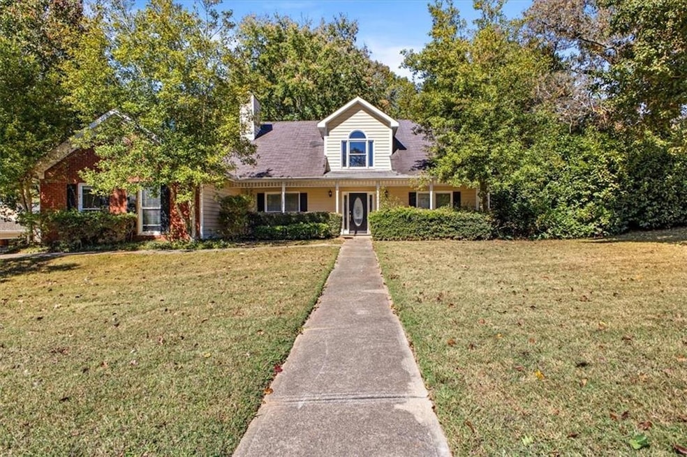 Cape cod-style house featuring a porch and a front lawn