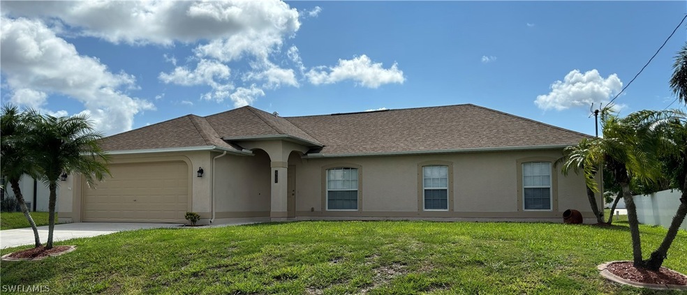 Ranch-style house with a garage and a front lawn