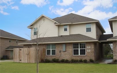 Back of house featuring a yard