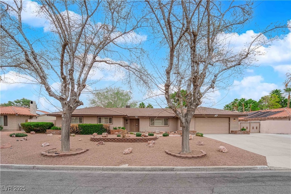 Ranch-style home with stucco siding, driveway, and