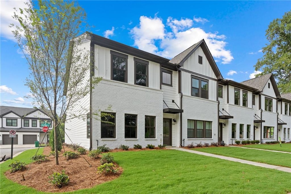View of front facade featuring a front yard, board