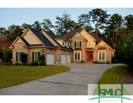 Exterior Front. Dramatic brick home features 3 car