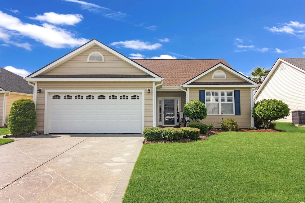 Ranch-style house with concrete driveway, a front lawn, a garage, and roof with shingles