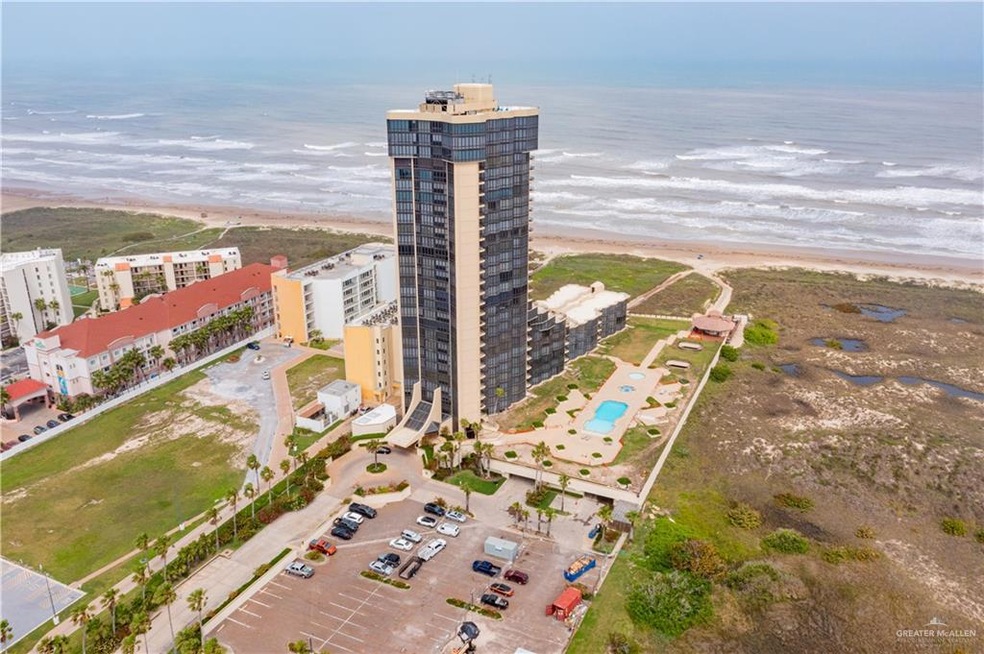 Aerial view featuring a water view, a beach view, and a city view