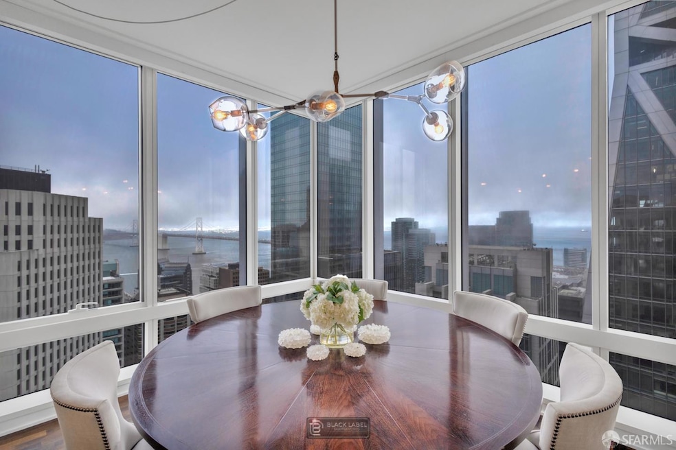 Dine above the clouds with the Bay Bridge sparkling beyond your table—this is the soul of Unit 40D.