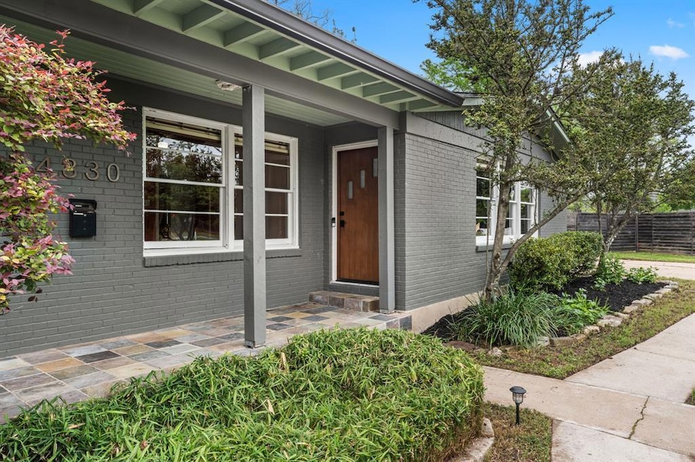 Entrance to property featuring brick siding