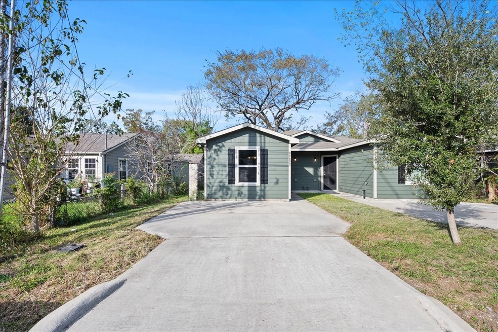 A single-story duplex with a long driveway, offeri