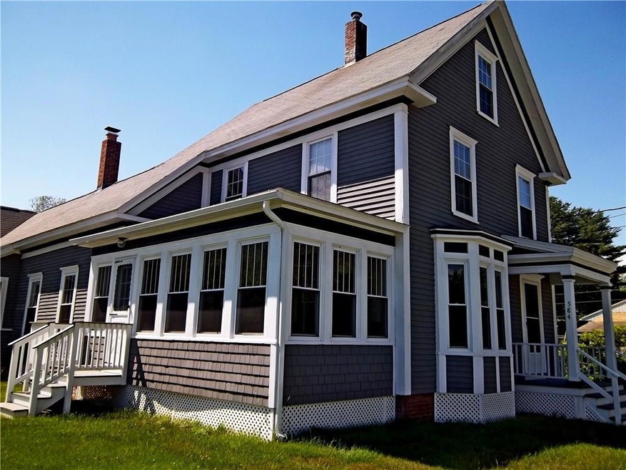 Front door and side porch of...