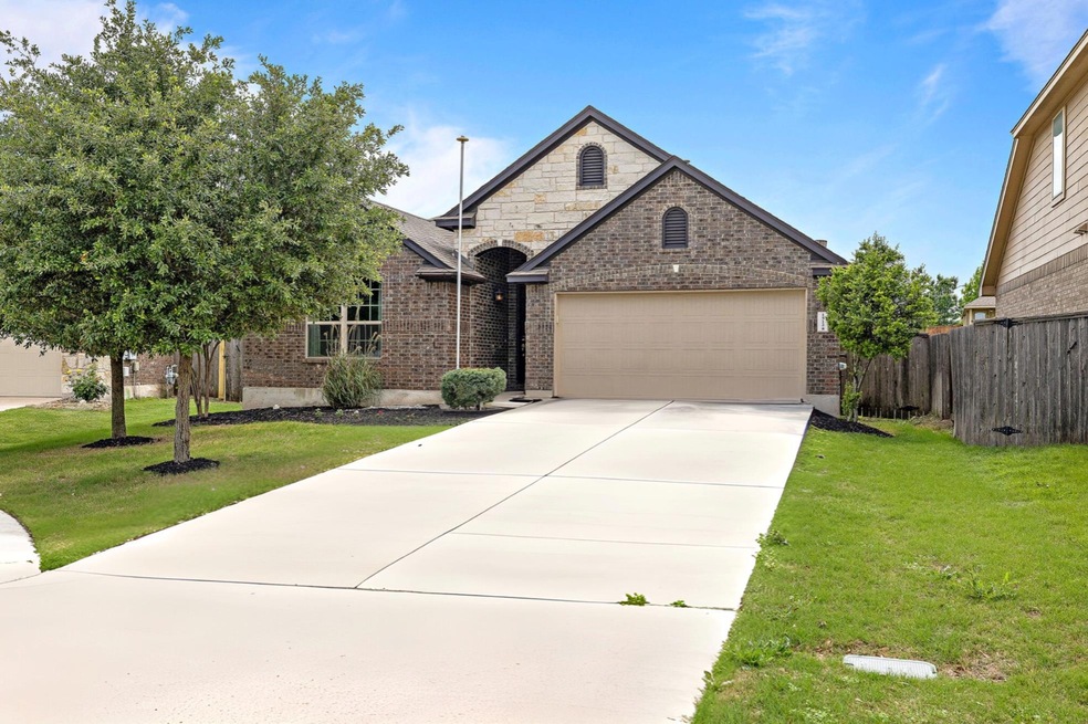 View of front of house featuring brick siding, an