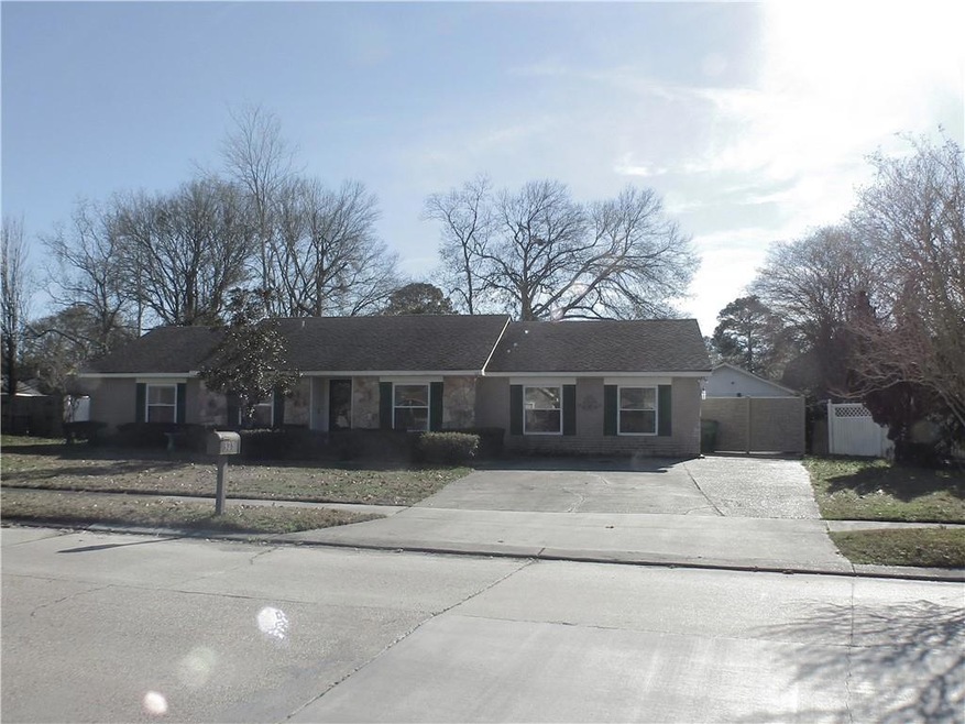 Front of house with extra wide driveway, rolling f