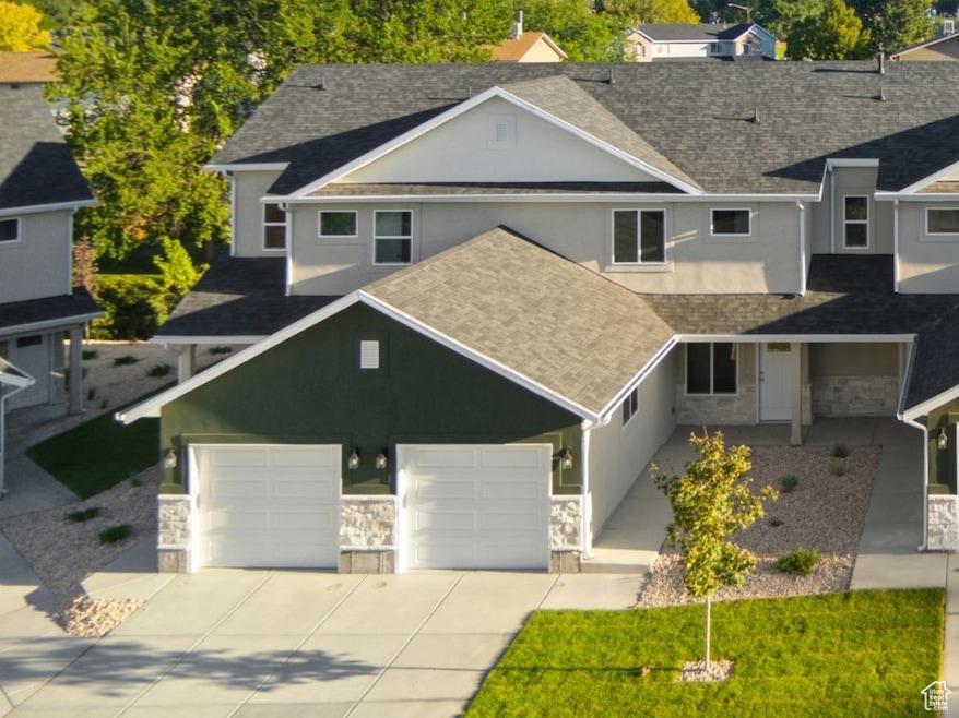View of front facade with stone siding, driveway, and a mountain view