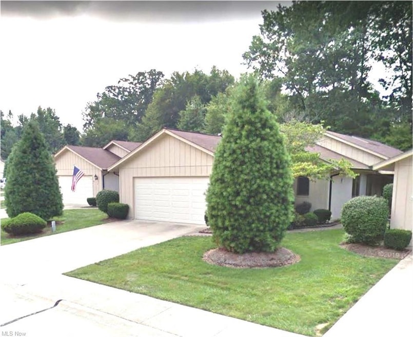 View of front of property with garage and a front yard