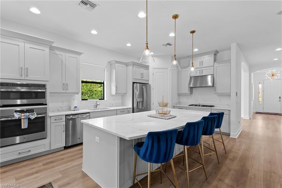 Kitchen featuring visible vents, a kitchen island,