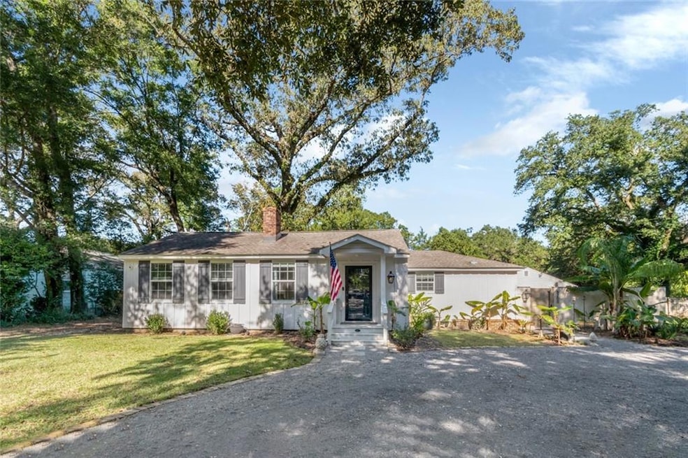 Ranch-style house featuring a front lawn