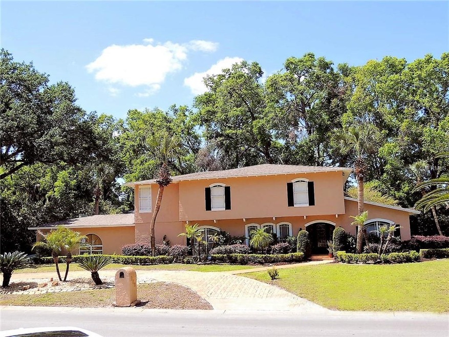 Front of home with circular driveway plus an extra
