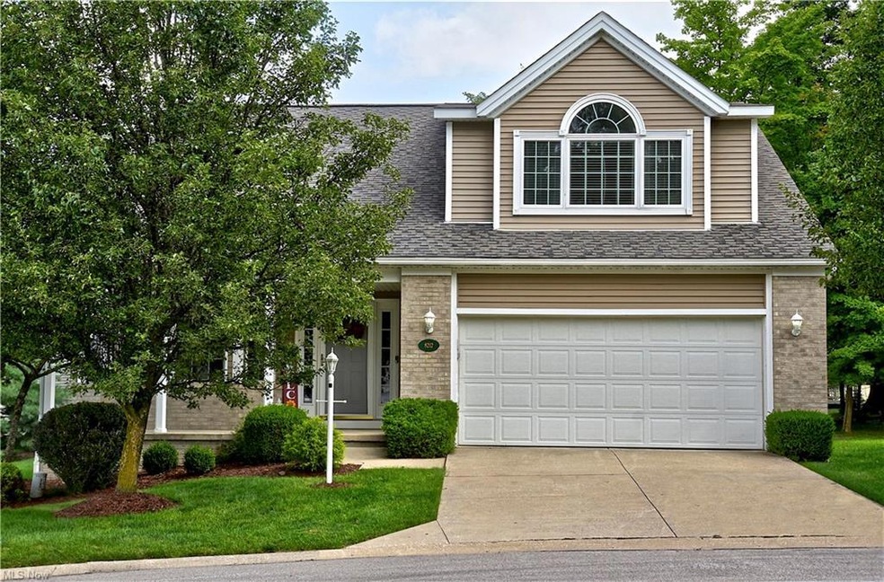 View of front of house featuring garage and a front lawn