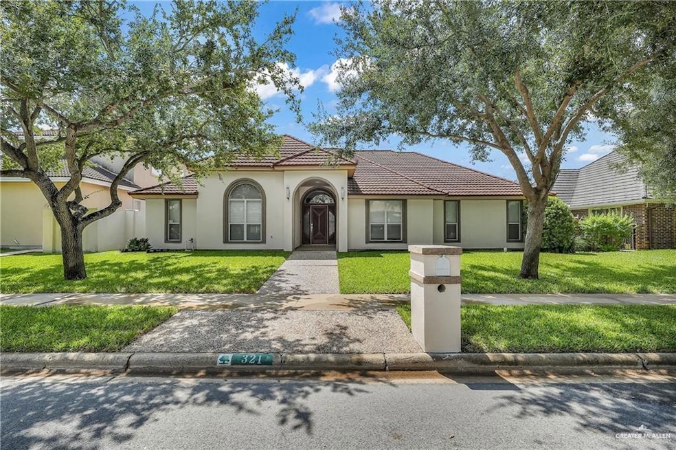 Mediterranean / spanish-style home featuring a tiled roof, a front lawn, and stucco siding