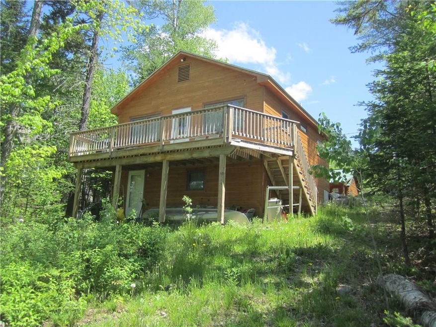 Back of cottage with large deck for...