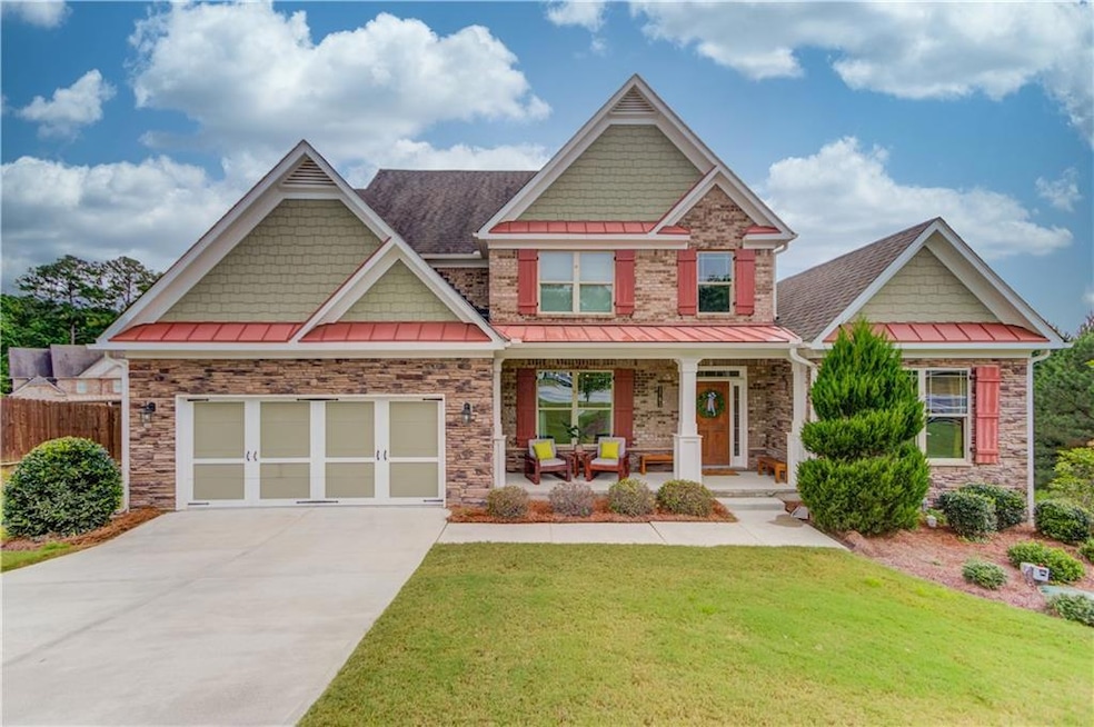 Craftsman house with a front lawn, a garage, and covered porch