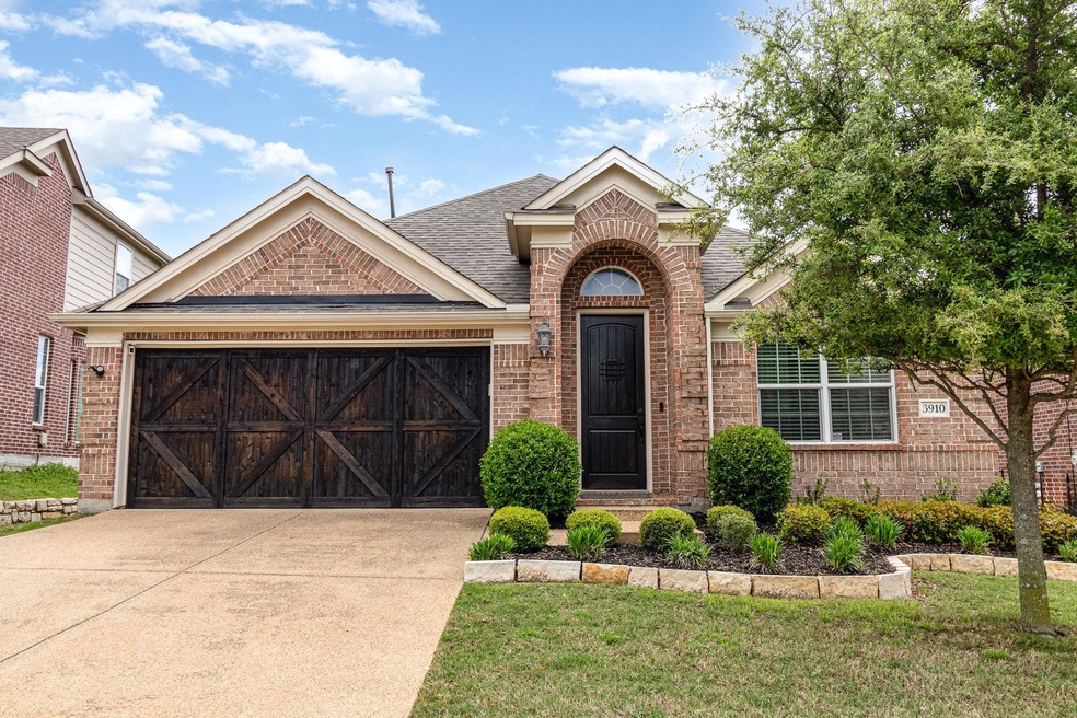 View of front of home with a front lawn and a garage