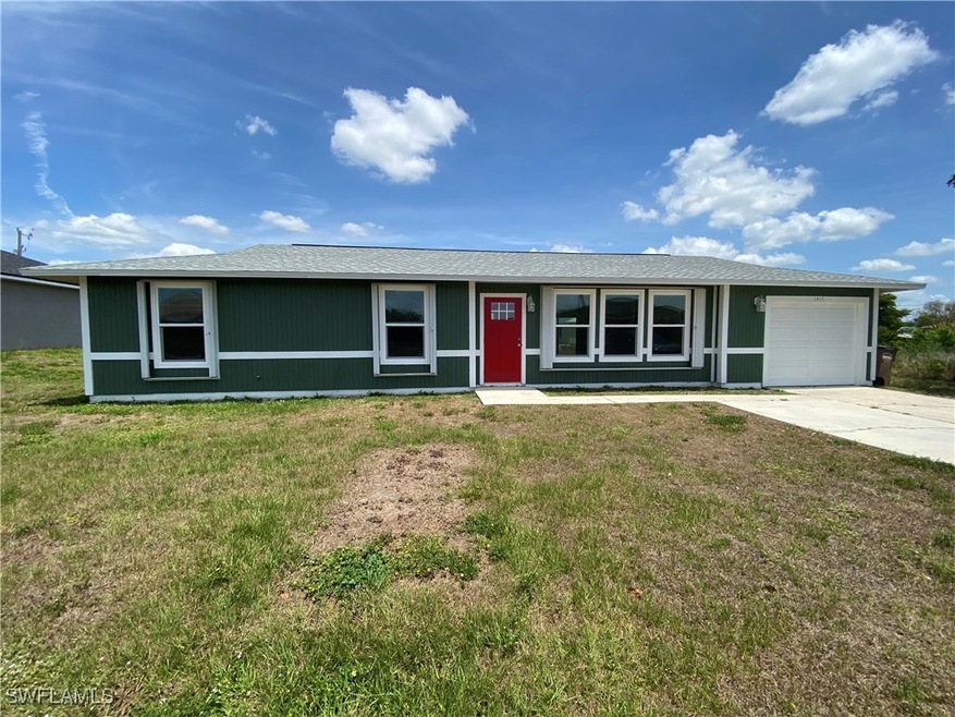 Single story home featuring a garage, a front lawn