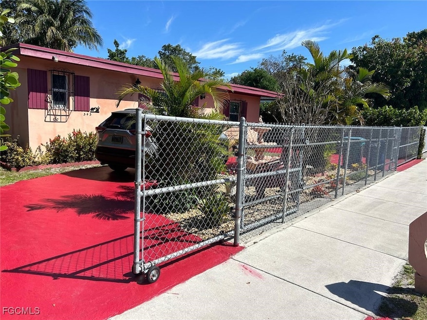 View of front of property with a gate and stucco s