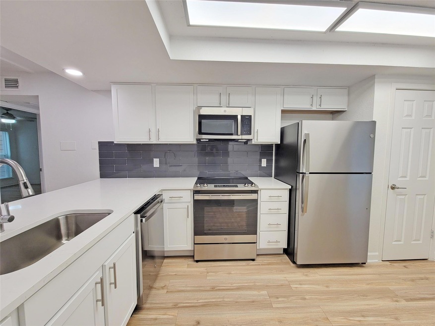Kitchen featuring sink, light hardwood / wood-styl