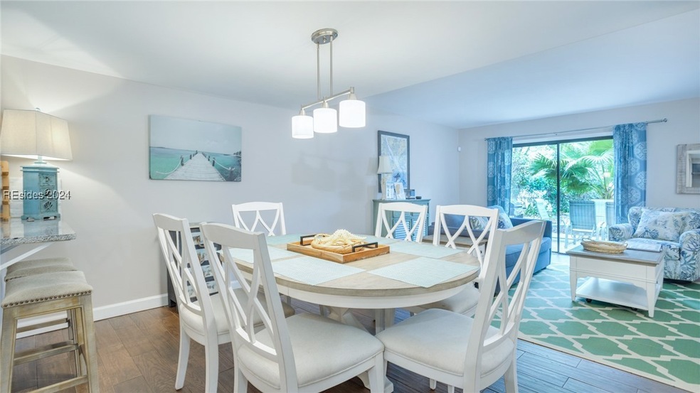 Dining room with dark hardwood / wood-style floori