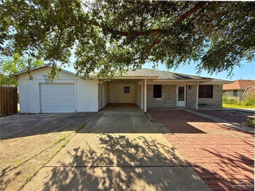 Ranch-style home featuring driveway, brick siding, and a garage