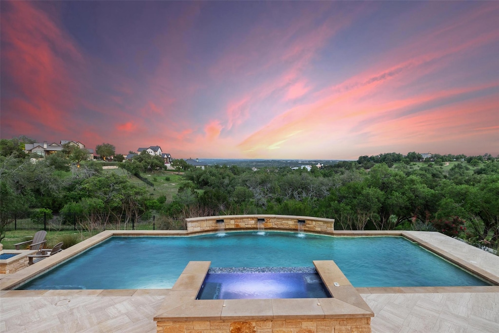 Pool at dusk featuring a pool with connected hot 