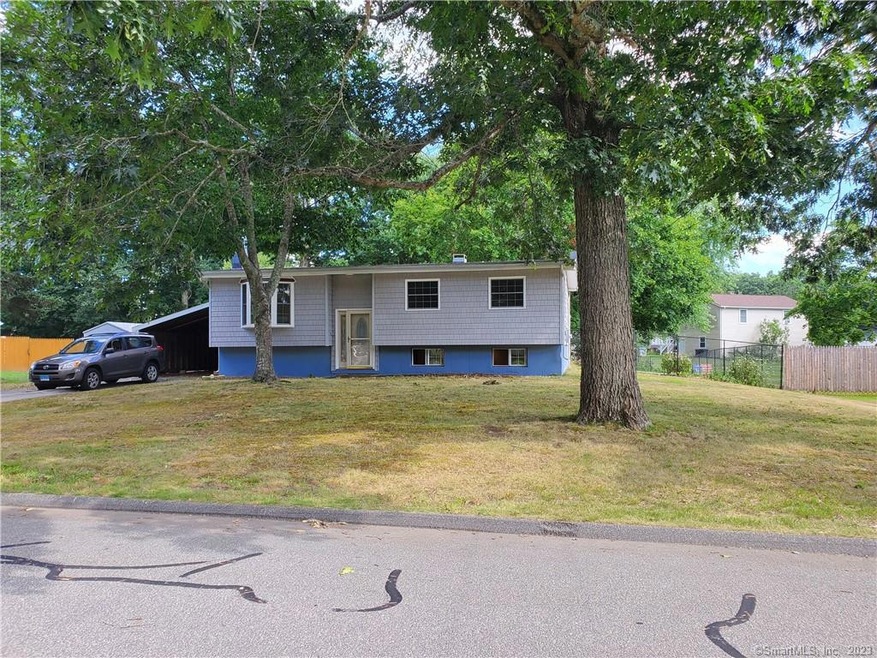 A sweeping front yard is graced by established oak