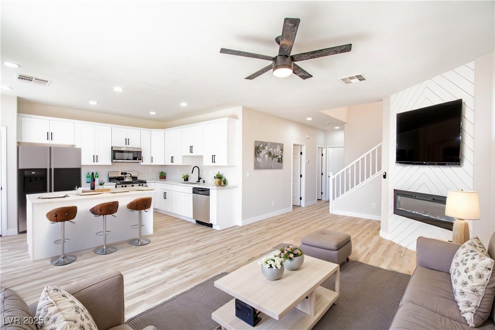 Living area with light wood-style flooring, a ceil