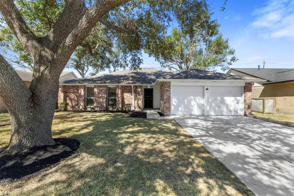 The inviting front yard features meticulous landsc