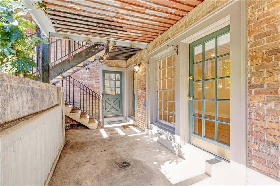 Entrance to property with a patio area and brick siding