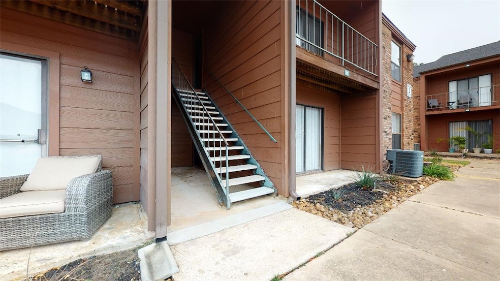 Property entrance with a garage and cooling unit
