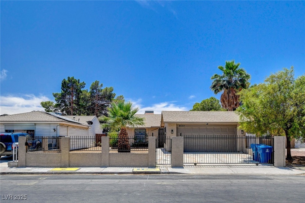 View of front of house with a garage, a fenced fro