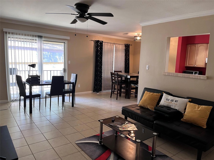 Living room featuring ceiling fan, crown molding, 