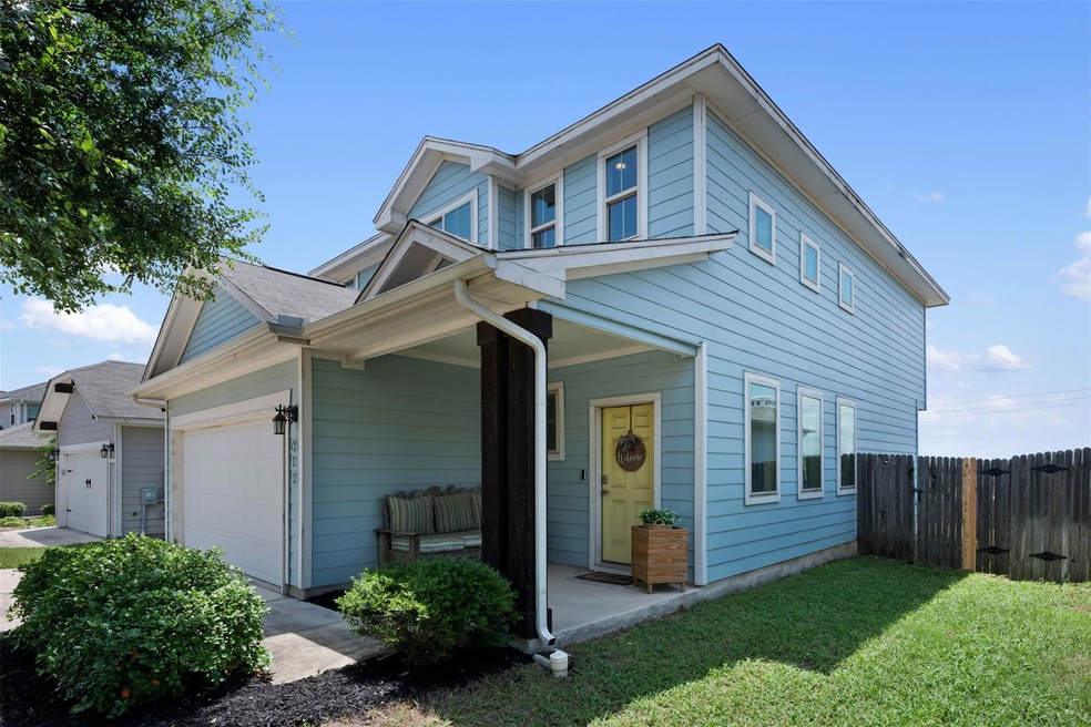 View of front of house with a garage and a porch