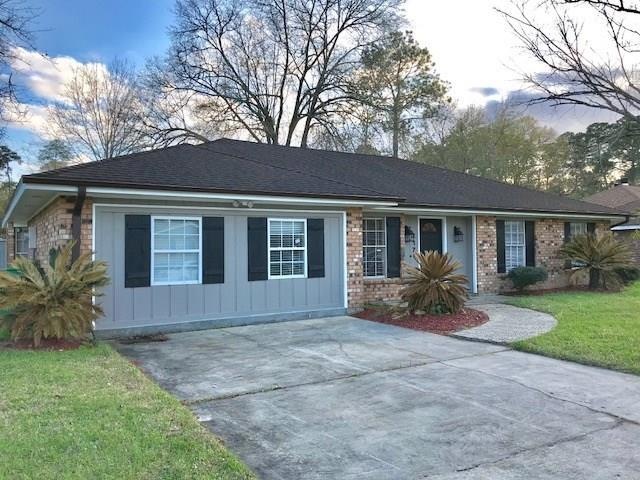 Front exterior-wide driveway, nice landscaping, si