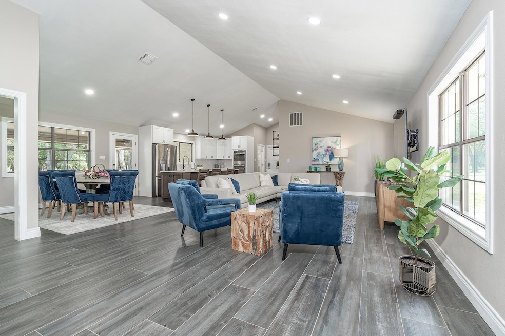 Living area featuring dark wood-style flooring, r