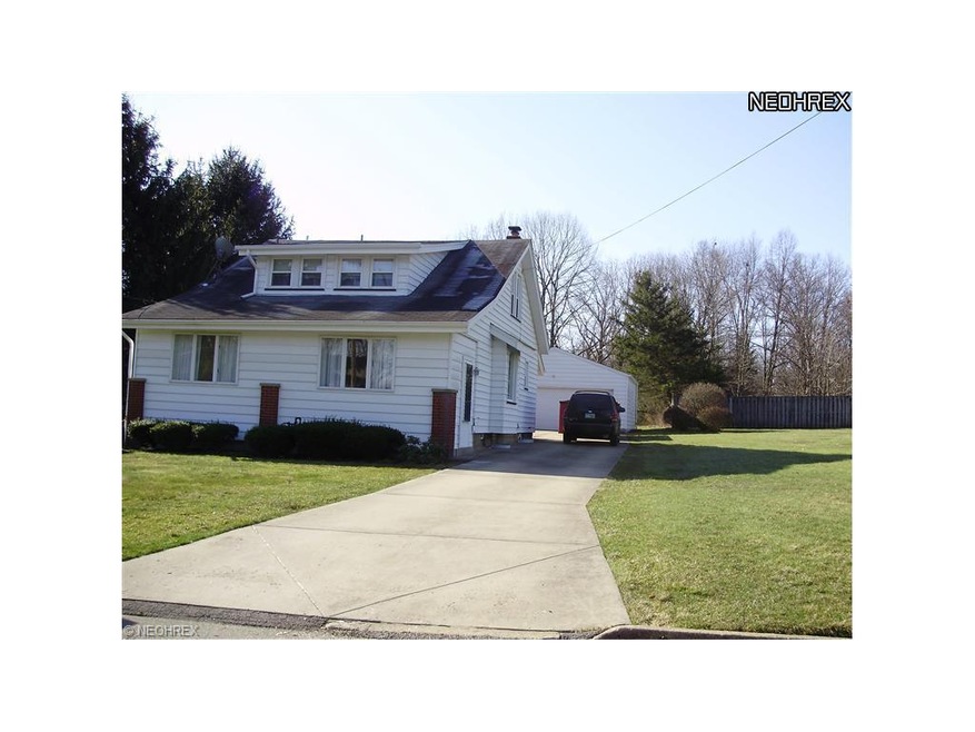 Front of house, large enclosed porch in front, two