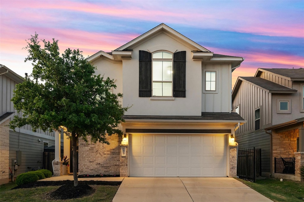 Traditional home featuring brick siding, an attac