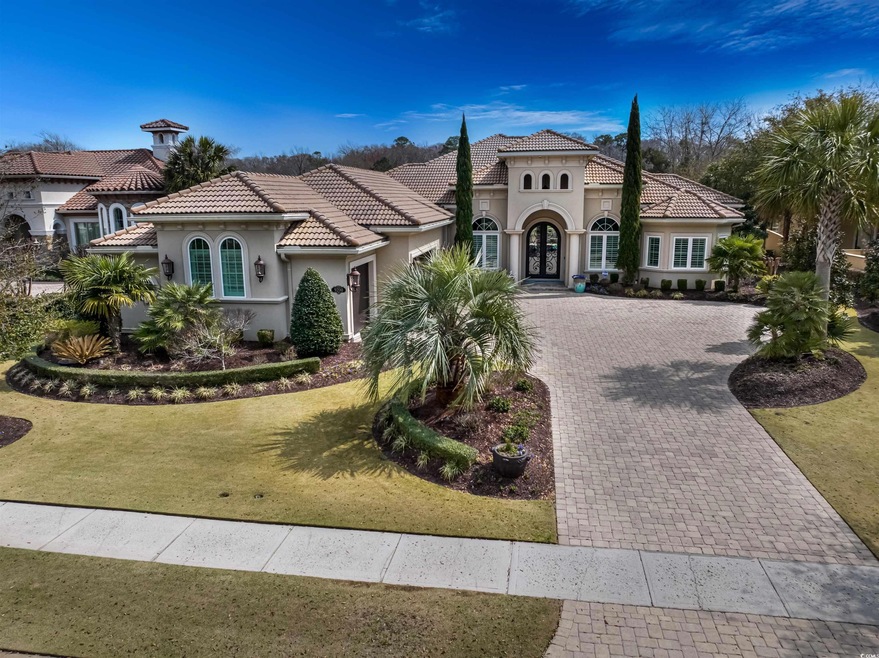 Mediterranean / spanish-style house with a tiled roof, decorative driveway, a garage, and stucco siding