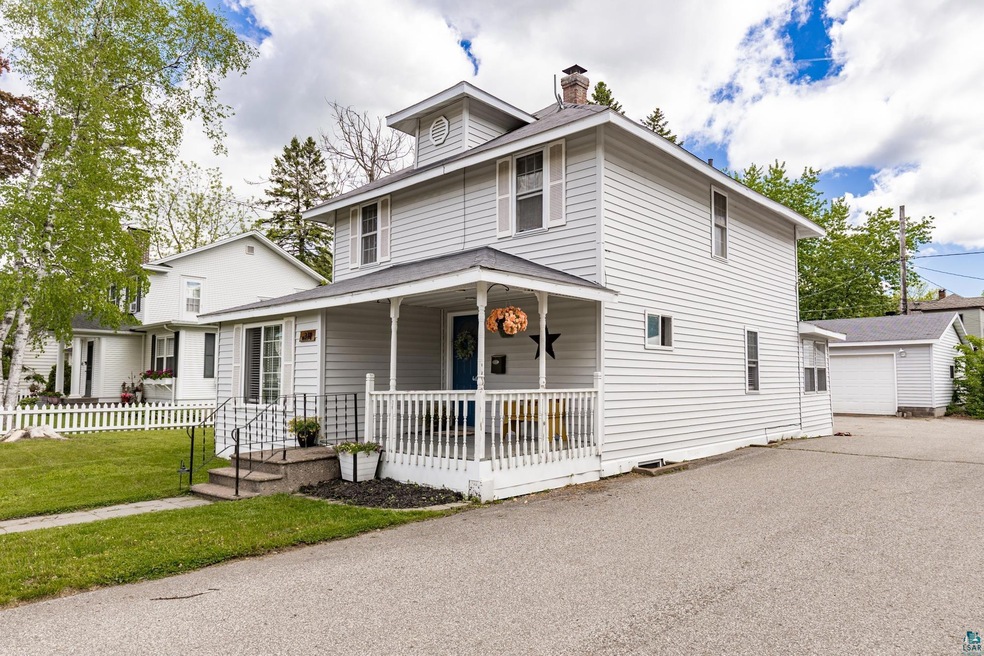 View of front of property with covered porch, an o