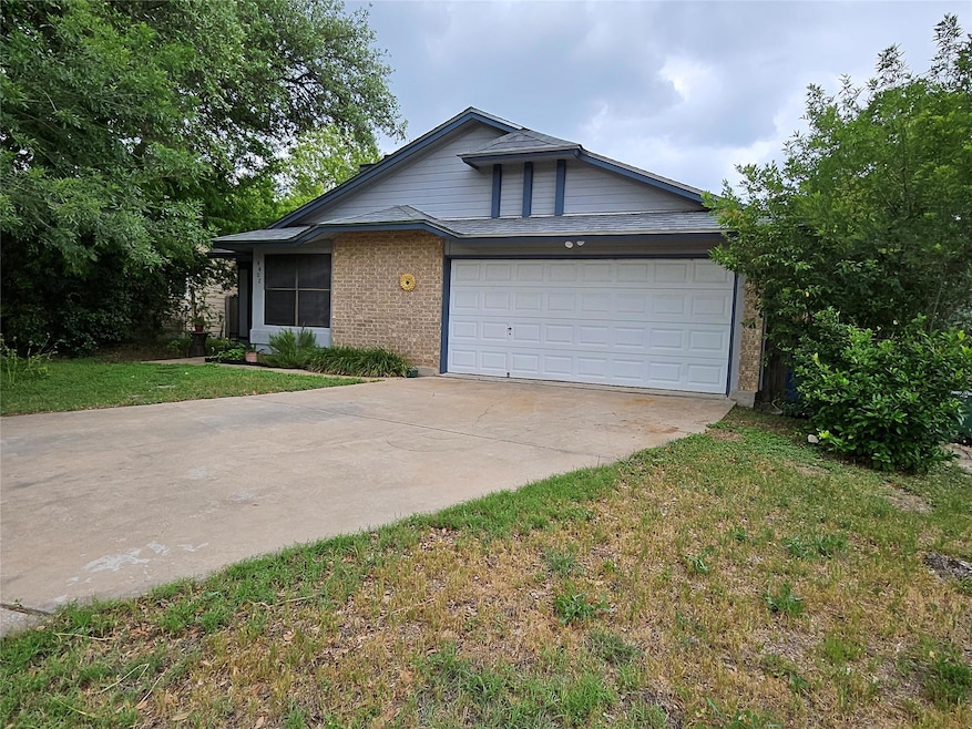 View of front facade with concrete driveway, a ga