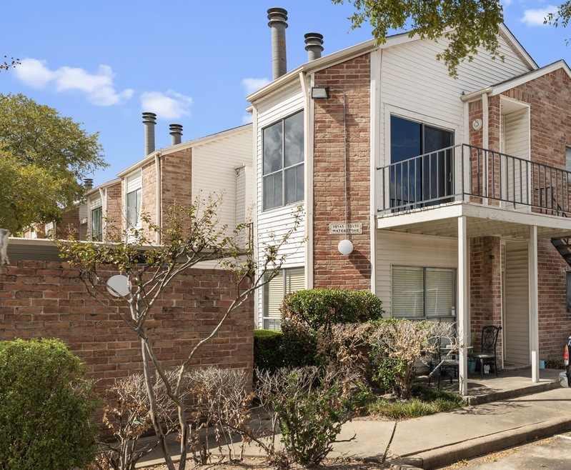 Nice corner one-bedroom on the second level in Woodchase Village has modern updates.