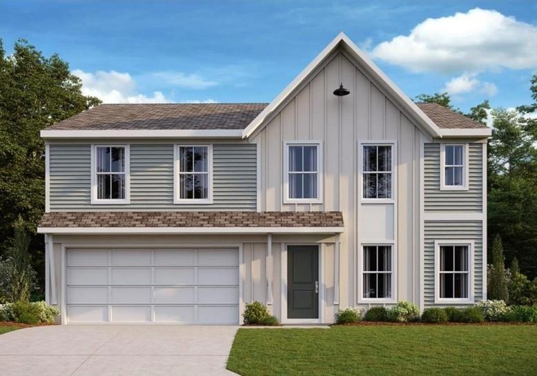 View of front of home with a garage and a front la