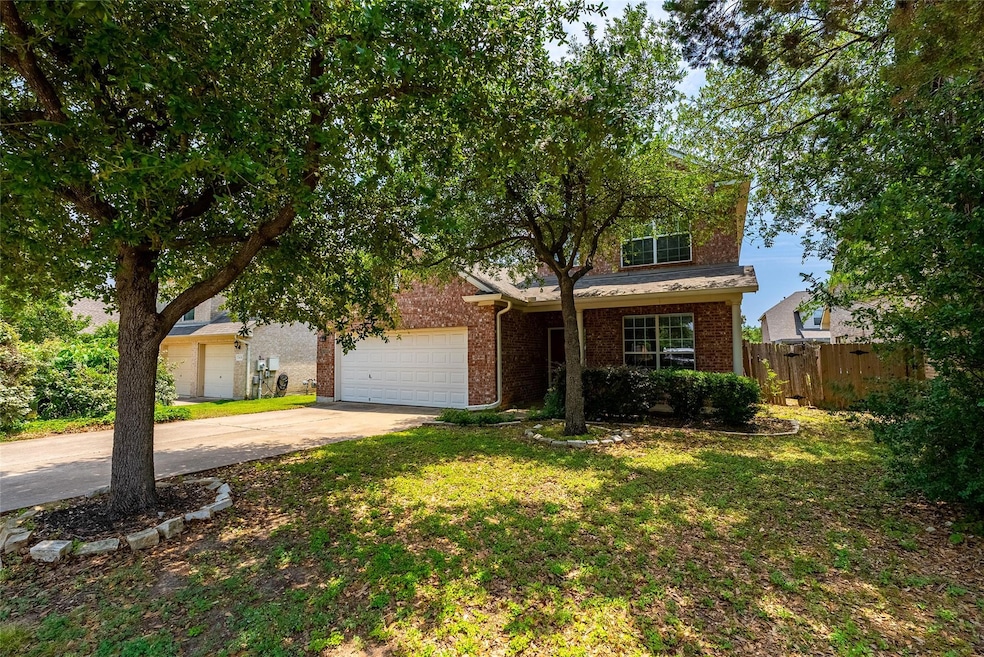 View of front of house featuring driveway, brick 