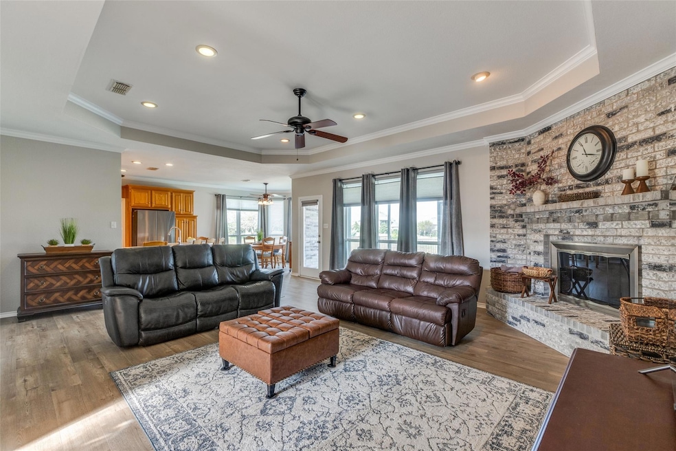 Living room with a tray ceiling, light LVP floors,