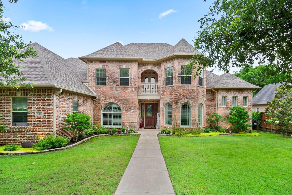 View of front of house featuring a front yard and a balcony